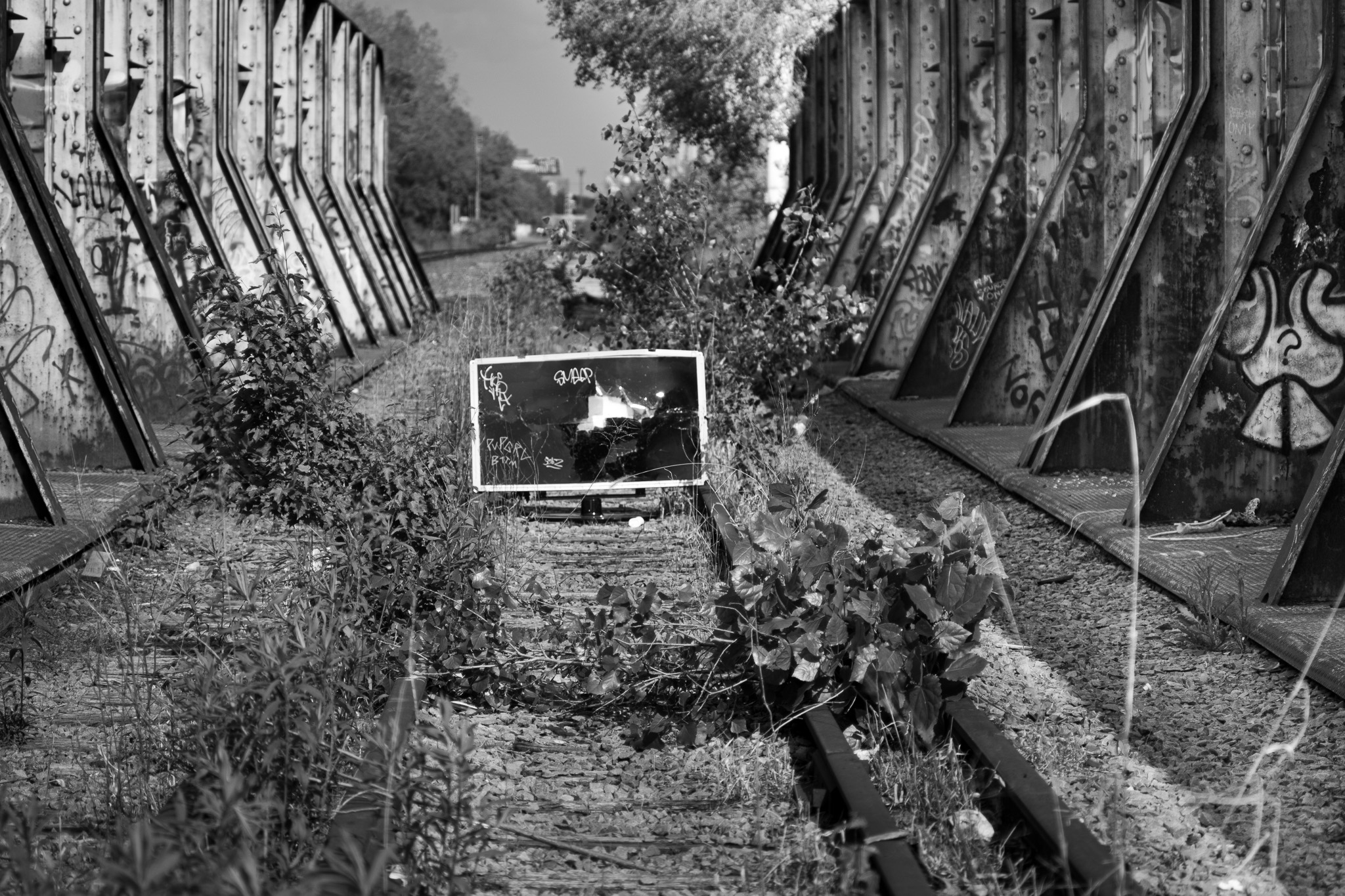 photo of a flat screen television on railroad tracks